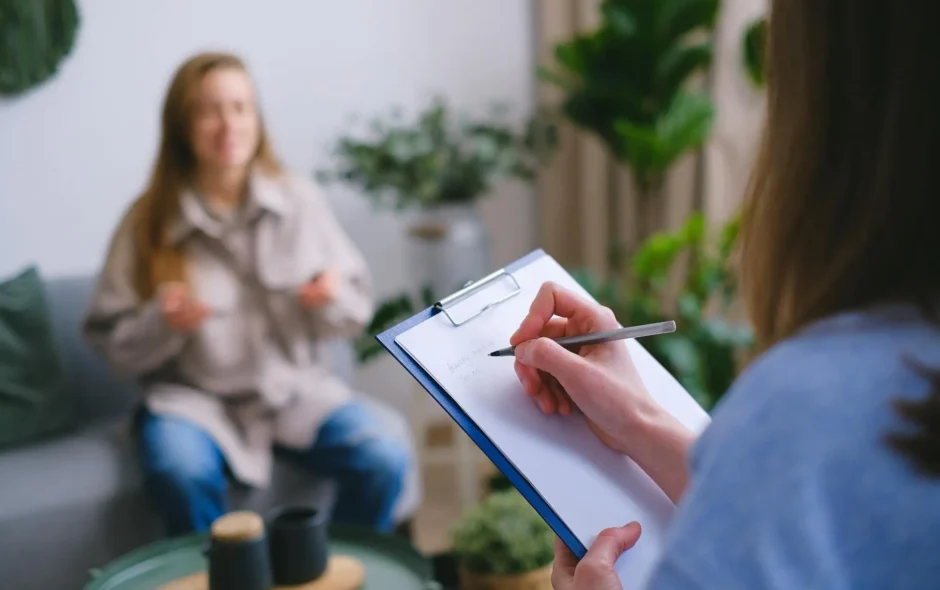 Woman seated on couch with therapist
